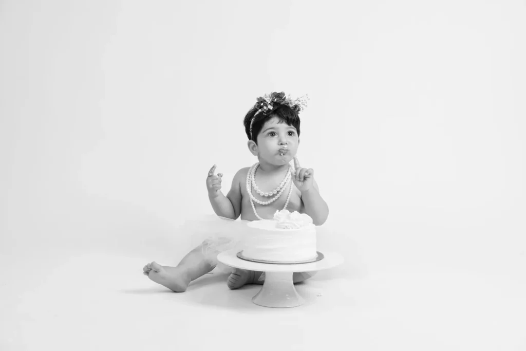 One-year-old baby enjoying a cake smash during a professional studio session