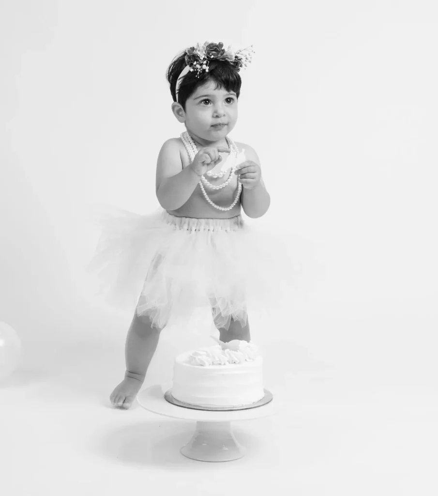 One-year-old child photographed in a bright studio during a first birthday session