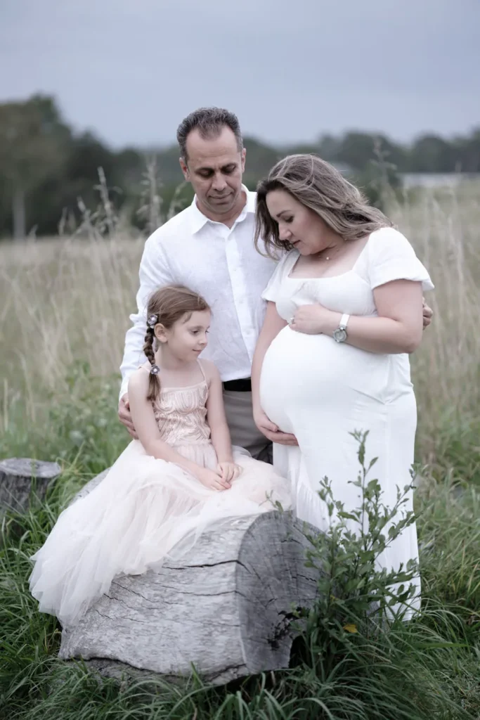 Pregnant mother with partner and child during an outdoor family maternity session