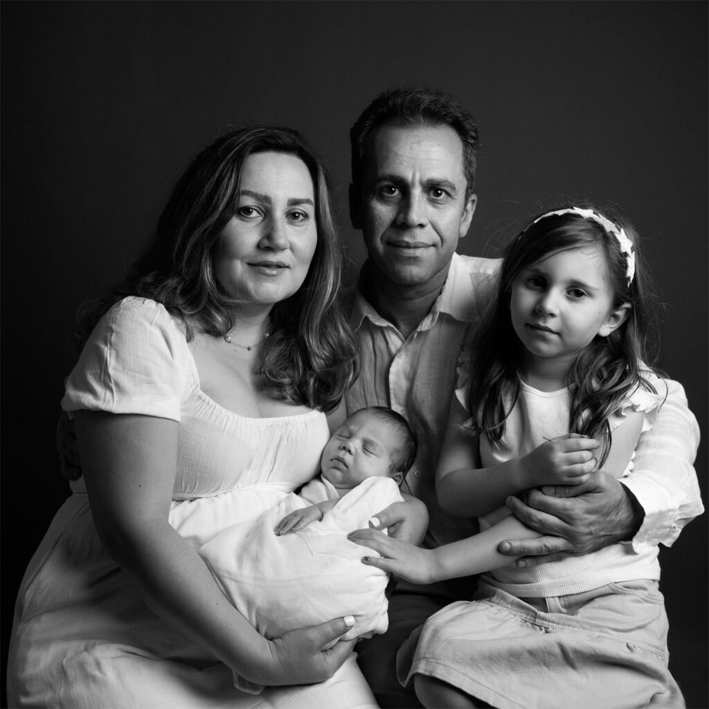 Family maternity studio portrait with parents and young daughter in Sydney