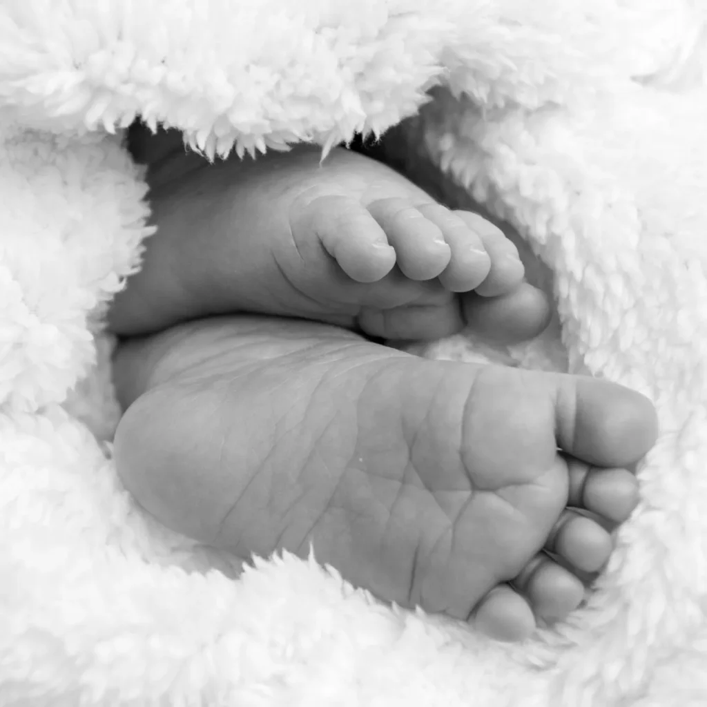 Close-up black and white photograph of newborn baby feet