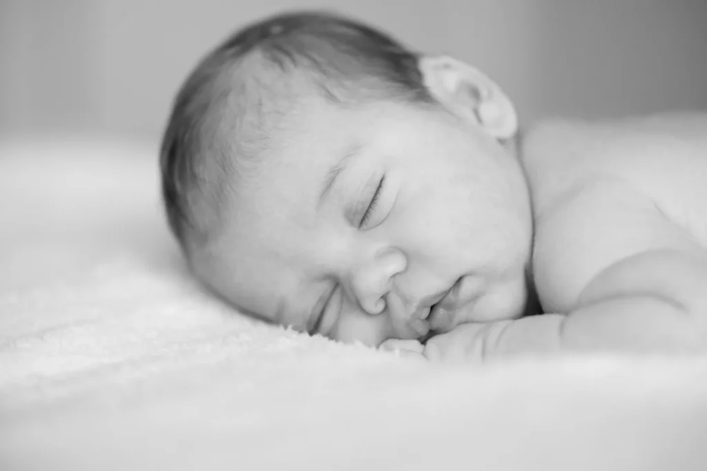 Sleeping newborn baby photographed softly during a professional newborn session